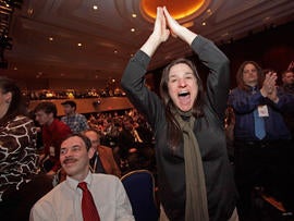 Pamela Sanderon, of Lansing, Mich., jumps out of her seat while cheering for Rep. Ron Paul