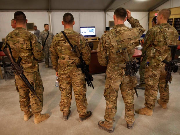 U.S. troops stationed at Kandahar Airfield, Afghanistan, watch breaking news on the announcement by President Barack Obama that Osama bin Laden had been killed.