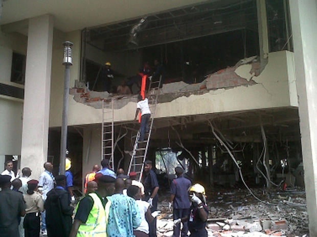 firefighters and rescue workers after a large explosion struck the United Nations' main office in Nigeria's capital Abuja