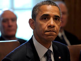 President Obama listens as a reporter asks a question at the start of a Cabinet meeting at the White House in Washington Oct. 3, 2011.