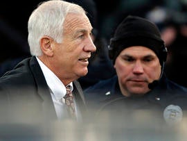 Jerry Sandusky, left, the former Penn State assistant football coach charged with sexually abusing boys, arrives for a preliminary hearing at the Centre County Courthouse in Bellefonte, Pa., where he was to face his accusers Dec. 13, 2011.