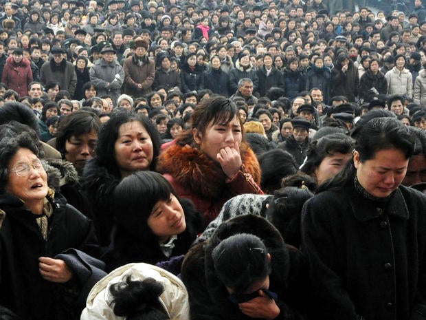 North Koreans grieve as they visit a portrait of the late leader Kim Jong Il at Kim Il Sung Square in Pyongyang, North Korea, Dec. 21, 2011.
