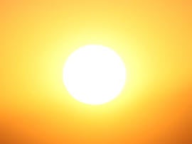 huge yellow fireball at sunset