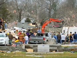 Emergency responders work to clear debris in a neighborhood in Harrisburg, Ill., after an early morning tornado Wednesday, Feb. 29, 2012.