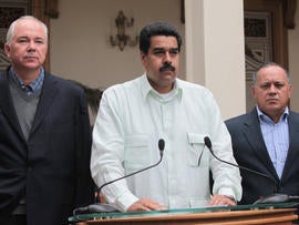 In this photo released by Miraflores Press Office, Venezuela's Vice President Nicolas Maduro, center, addresses the nation on live television flanked by Oil Minister Rafael Ramirez, left, and National Assembly President Diosdado Cabello at the Miraflores presidential palace in Caracas, Venezuela, Wednesday, Dec. 12, 2012. Maduro said that Venezuela's President Hugo Chavez will face a "complex and hard" process after undergoing his fourth cancer-related operation in Cuba on Tuesday. Over the weekend, Chavez named Maduro as his chosen political heir.