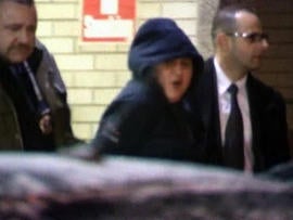 Erika Menendez, center, is led away by police Dec. 29, 2012, in New York.