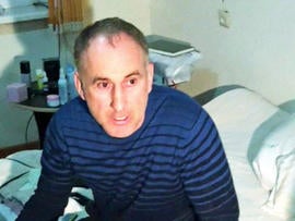 In this image taken from a mobile phone video, the father of USA Boston bomb suspects, Anzor Tsaraev reacts as he talks to the media about his sons, in his home in the Russian city of Makhachkala, Friday April 19, 2013. One son is now dead, and one son Dzhokhar Tsaraev is still at large on Friday suspected in Monday's deadly Boston Marathon bombing which stunned friends who have pleaded for the surviving brother, described as bright and outgoing young man, to turn himself in and not hurt anyone.