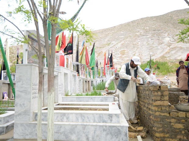 Workers at at Quetta's Behesht-e-Zainab cemetery