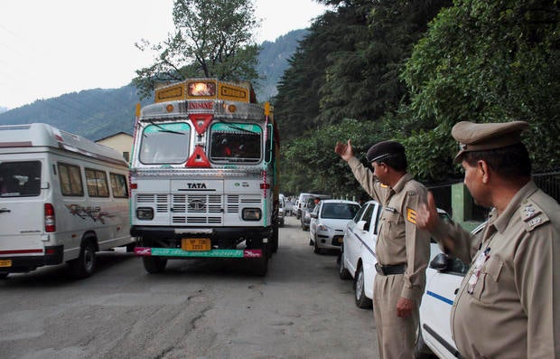 Indian policemen check vehicles after an American woman was gang-raped in the northern Indian resort town of Manali