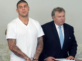 New England Patriots tight end Aaron Hernandez, left, stands with his attorney, Michael Fee, right, in Attleboro District Court June 26, 2013, in Attleboro, Mass.