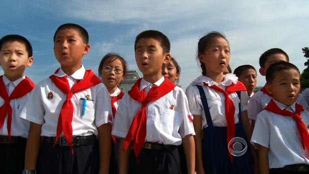 North Korean children sing at a ceremony in Pyongyang at the mausoleum holding Kim Jong Il.