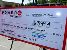 A giant check is displayed announcing a winner in the Powerball jackpot outside the Murphy Express store Sept. 19, 2013, in Lexington, S.C.