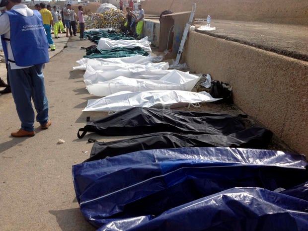 Bodies of drowned migrants are lined up in the port of Lampedusa, Italy, Oct. 3, 2013.
