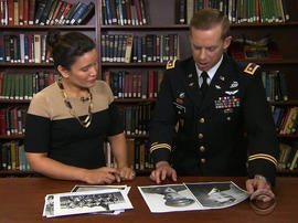Army Maj. Dwight Mears shows CBS News' Elaine Quijano photos of his grandfather, a U.S. airmen who was a POW in Switzerland.