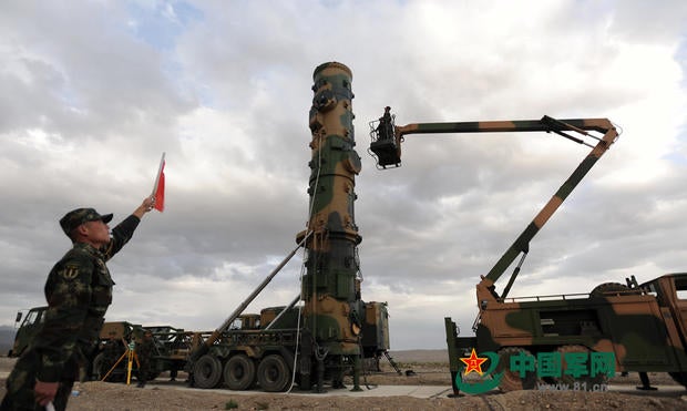 In a photo released by China's People's Liberation Army, soldiers prepare a mobile launch vehicle to test fire a Dongfeng-31 international ballistic missile