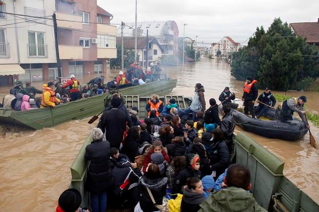 Serbian army soldiers evacuate people in amphibious vehicles in the flooded town of Obrenovac