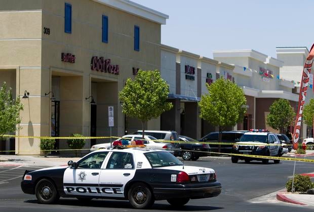 Metro Police patrol cars are used to block off access to CiCi's Pizza after a shooting in Las Vegas