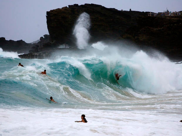 Bodysurfers and boogie boarders catch waves at Sandy Beach on the east side of Oahu as Tropical Storm Iselle passes through the Hawaiian islands in Honolulu, Hawaii, Aug. 8, 2014.