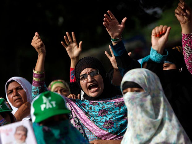 Supporters of Tahirul Qadri, Sufi cleric and leader of political party Pakistan Awami Tehreek (PAT), gesture as they chant slogans during the Revolution March in Islamabad Aug. 18, 2014.