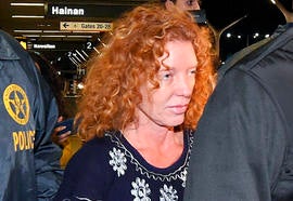 Tonya Couch is taken by authorities to a waiting car after arriving at Los Angeles International Airport Dec. 31, 2015, in Los Angeles.
