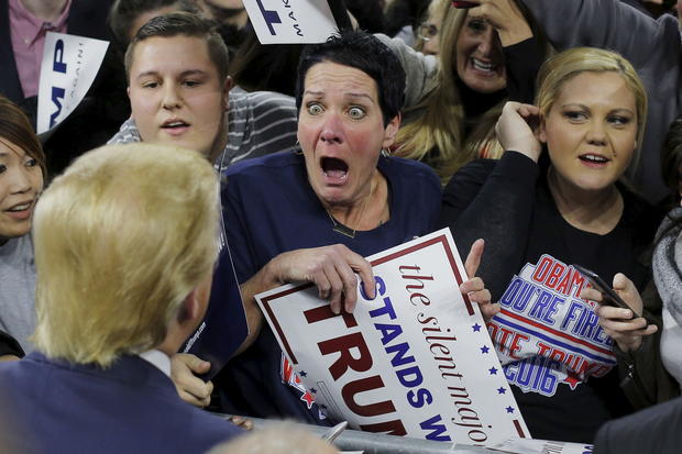 Audience member Robin Roy, center, reacts as Republican presidential candidate Donald Trump greets her at a campaign rally in Lowell, Massachusetts, Jan. 4, 2016.