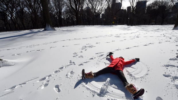 Tara Jakeway with "Chasing News" makes a snow angel in the man-made snow in Central Park Jan. 20, 2016, as part of Winter Jam NYC's Ultimate Snow Day.