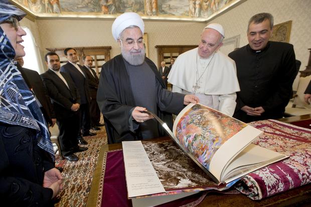 Iran President Hassan Rouhani exchanges gifts with Pope Francis at the Vatican