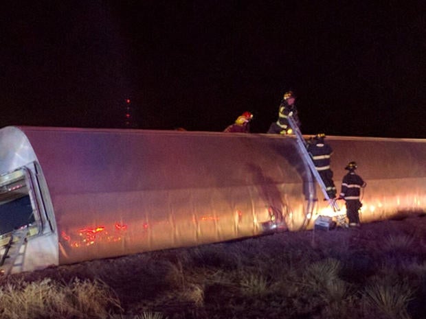 Firefighters on scene of Amtrak derailment west of Dodge City, Kansas early on March 14, 2016