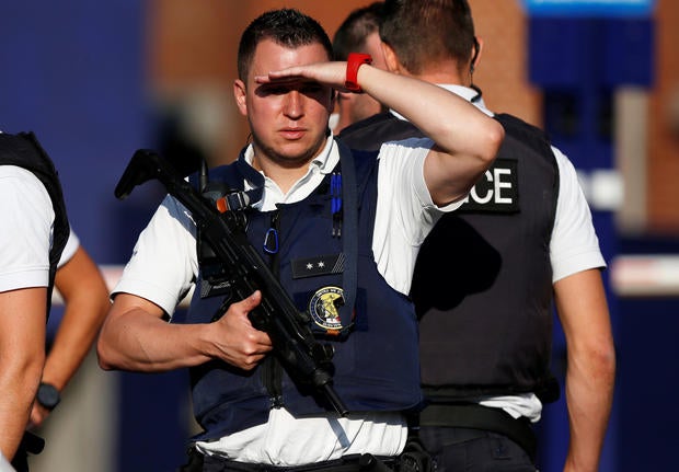 Belgian police officers stand guard outside the main police station after a machete-wielding man injured two female police officers before being shot in Charleroi, Belgium, Aug. 6, 2016.