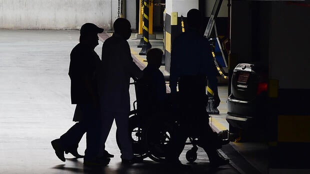 International Olympic Committee member Patrick Hickey leaves in a wheelchair from Samaritano Barra Hospital after being arrested on allegations of taking part in a black market ticket ring, on Aug. 18, 2016, in Rio de Janeiro, Brazil.