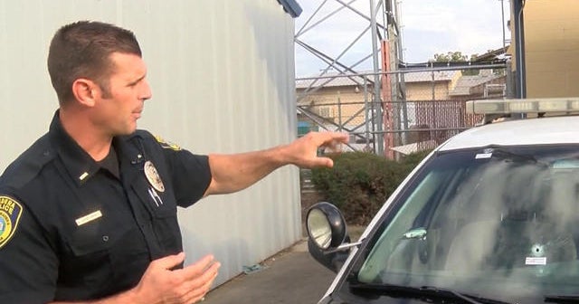 California driver shoots at police cruiser carrying passenger - CBS News