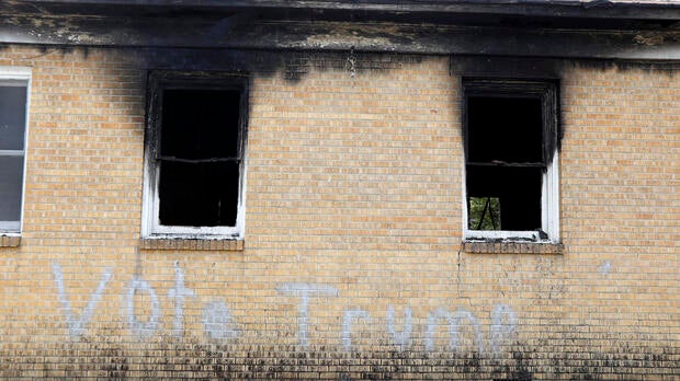 “Vote Trump” is spray-painted on the side of the fire-damaged Hopewell M.B. Baptist Church in Greenville, Miss., Nov. 2, 2016.