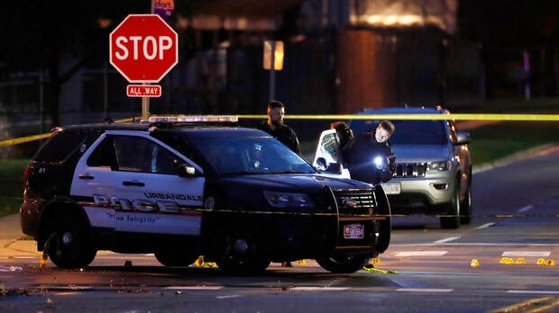 Police officers gather evidence at the scene of a shooting Nov. 2, 2016, in Urbandale, Iowa. Two Des Moines area police officers were shot to death in ambush-style attacks while they were sitting in their patrol cars.