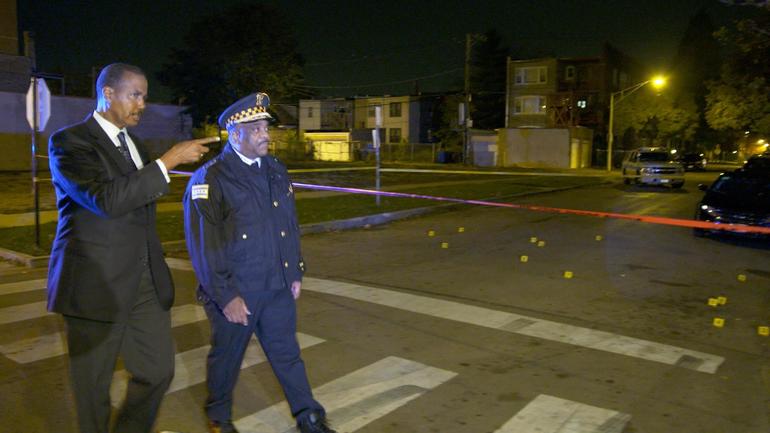eddie-johnson-and-whitaker-walk-and-talk-at-crime-scene.jpg