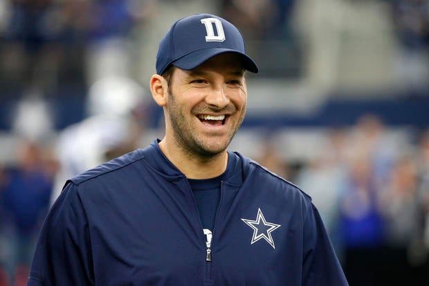 Dallas Cowboys quarterback Tony Romo smiles as he talks with teammates on the field during warmups before an NFL football game against the Cincinnati Bengals on Sun., Oct. 9, 2016, in Arlington, Texas.