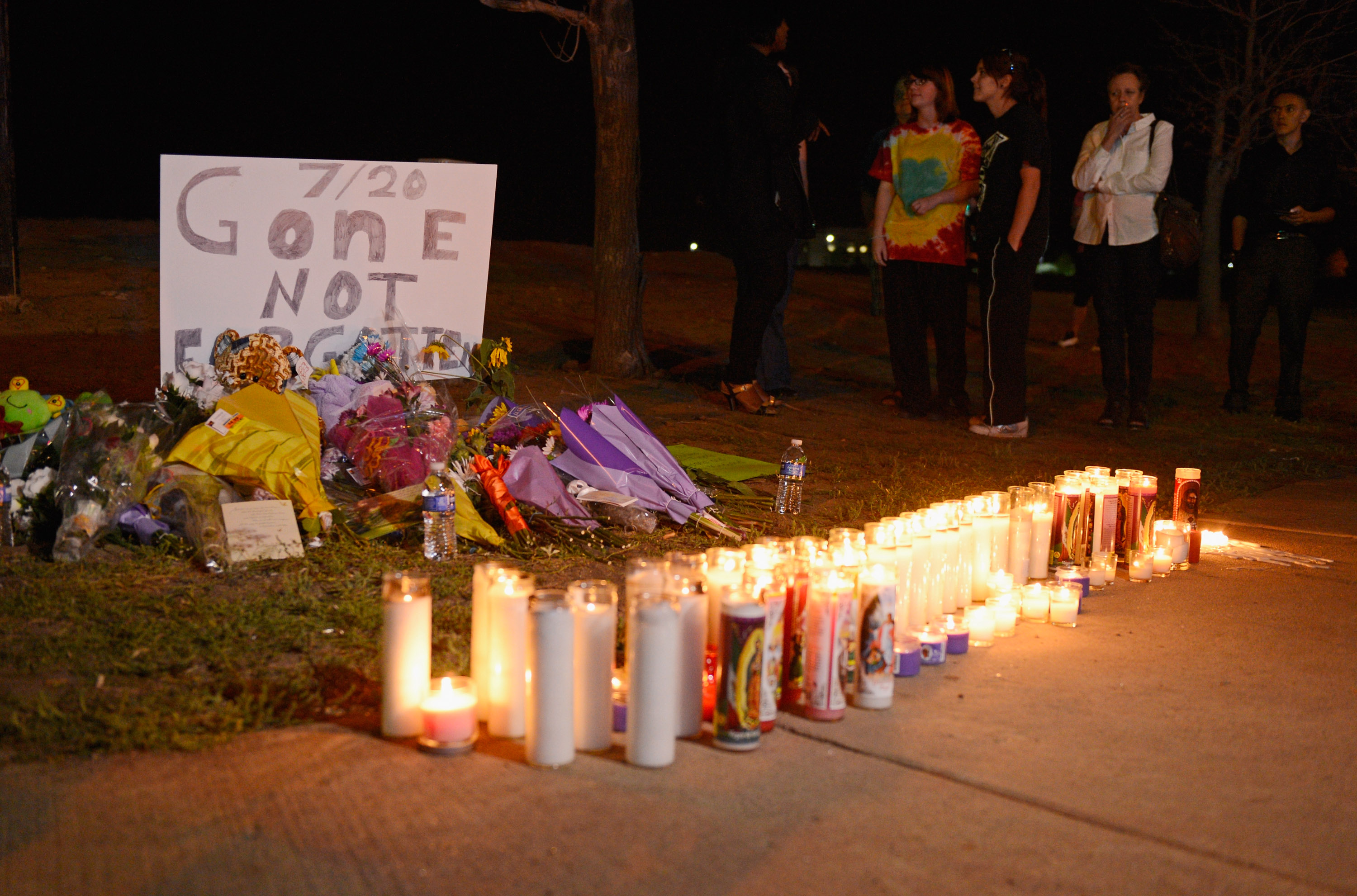 People gather at a makeshift memorial for victims of the Century 16 movie theatre  