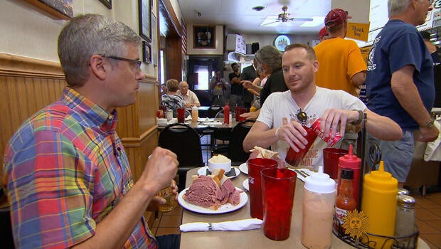 mo-rocca-mike-polk-jr-corned-beef-sandwich-at-slymans-cleveland-620.jpg