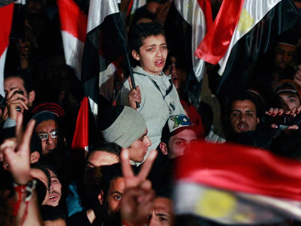Egyptian boy cries with emotion as he and others celebrate