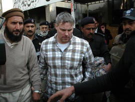 Pakistani security officials escort Raymond Allen Davis