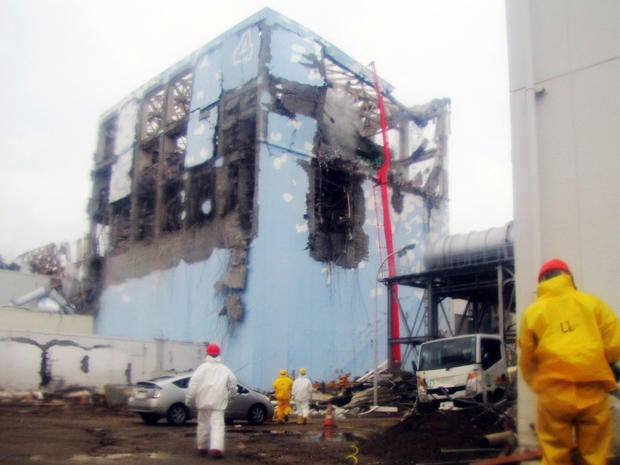 Workers spray water on reactor Number 4 at Fukushima Dai-ichi nuclear plant