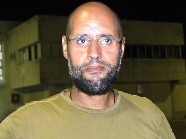 Saif al-Islam Qaddafi, son of ousted Libyan leader Muammar Qaddafi, appears in front of journalists at his father's residential complex in the Libyan capital of Tripoli Aug. 23, 2011.