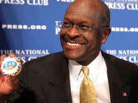 Republican presidential candidate, Herman Cain holds up a muffin that has his catch-phrase 9-9-9 tax plan printed on it, before speaking at the National Press Club in Washington, Monday, Oct. 31, 2011.