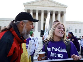 Richard Mondale yells at a Obama health care reform supporter during a protest in front of the U.S. Supreme Court building March 27, 2012, in Washington.