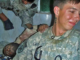 Soldiers from the Army's 82nd Airborne Division pose with the mangled corpose of a suicide bomber in Afghanistan's Zabol province. The image was first published in the LA Times, which received it from an unnamed soldier in the division.In this image provided to the LA Times by a soldier in the division.