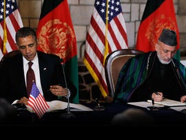 President Barack Obama and Afghan President Hamid Karzai sign a strategic partnership agreement at the presidential palace in Kabul, Afghanistan, Wednesday, May 2, 2012.