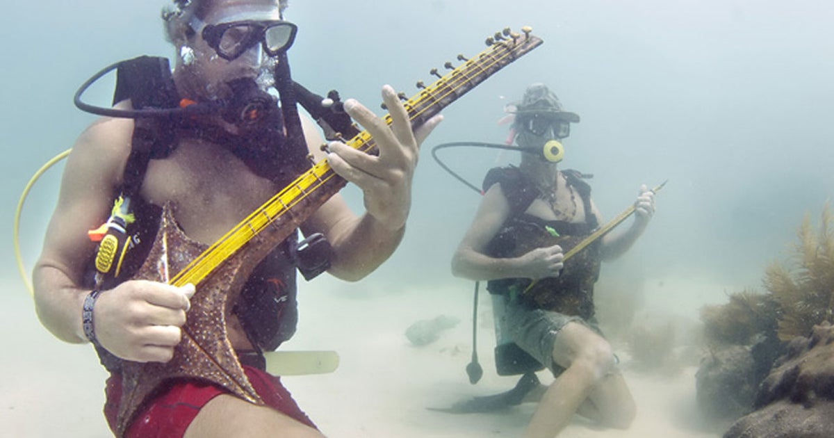 Divers jam under the sea during the Underwater Music Festival in the