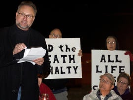 Reynold Nesiba, a death-penalty opponent, speaks to a crowd of protesters outside the South Dakota Penitentiary in Sioux Falls, S.D., on Monday, Oct. 15, 2012, in anticipation of the execution of Eric Robert. Robert pleaded guilty in the April 12, 2011, slaying of a guard during a failed prison escape and asked to be put to death, saying he would kill again. He was scheduled to die by lethal injection at 10 p.m. at the State Penitentiary in Sioux Falls_ the state's first execution in five years and only the second in more than half a century.