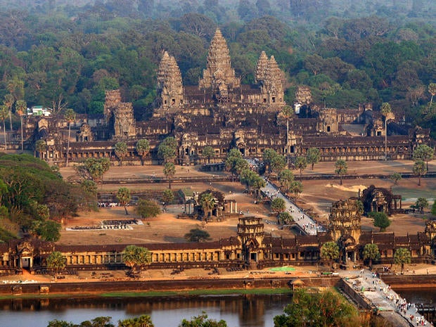 Siem Reap, CAMBODIA: An aerial view of the Angkor Wat temple in Siem Reap province some 314 kilometers northwest of Phnom Penh, 02 March 2007. Angkor is at the very heart of Cambodia's identity, and with nearly two million tourists coming to the country in 2006 -- more than half of those visiting Angkor -- it is recognising the need to keep these precious ruins intact. Some 500 years after a failing irrigation system forced Angkor's rulers to abandon the sprawling Khmer capital, a lack of water is again threatening Cambodia's most famous temple complex. AFP PHOTO/ TANG CHHIN SOTHY (Photo credit should read TANG CHHIN SOTHY/AFP/Getty Images)