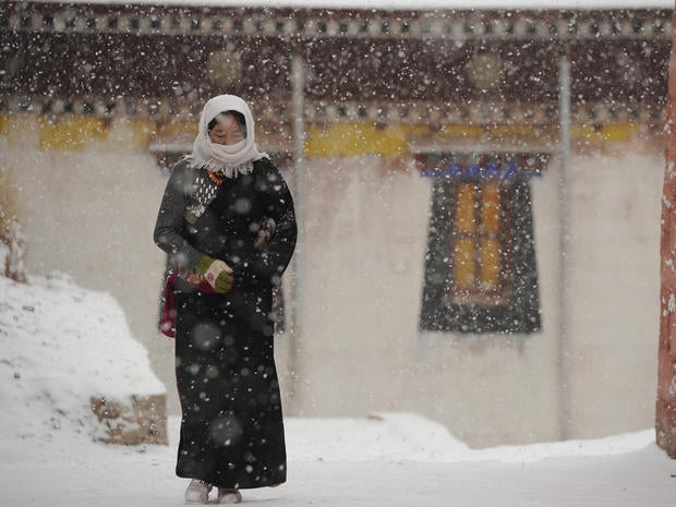 Tibetan pilgrim walks through Lajia Monastery in Qinghai province, China.