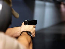 A man fires a handgun at Sandy Springs Gun Club and Range in Sandy Springs, Ga., Jan. 4, 2013.